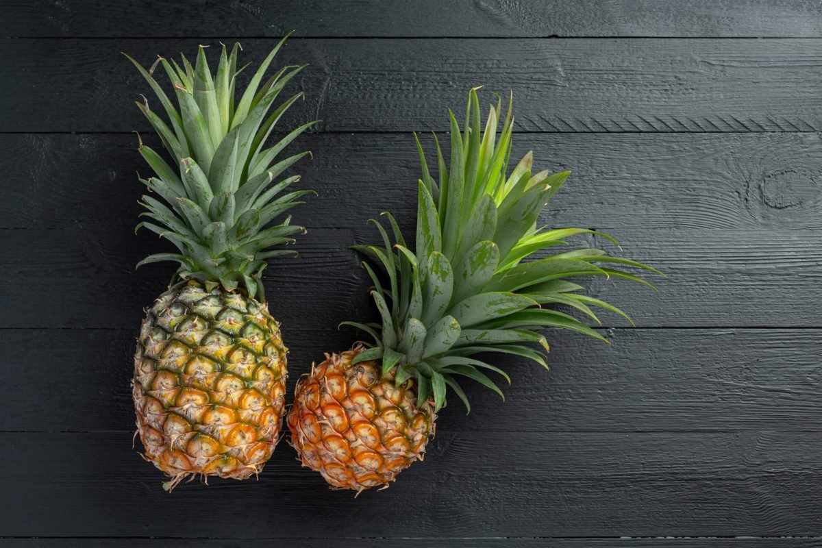 fresh pineapple on dark wooden backgroud