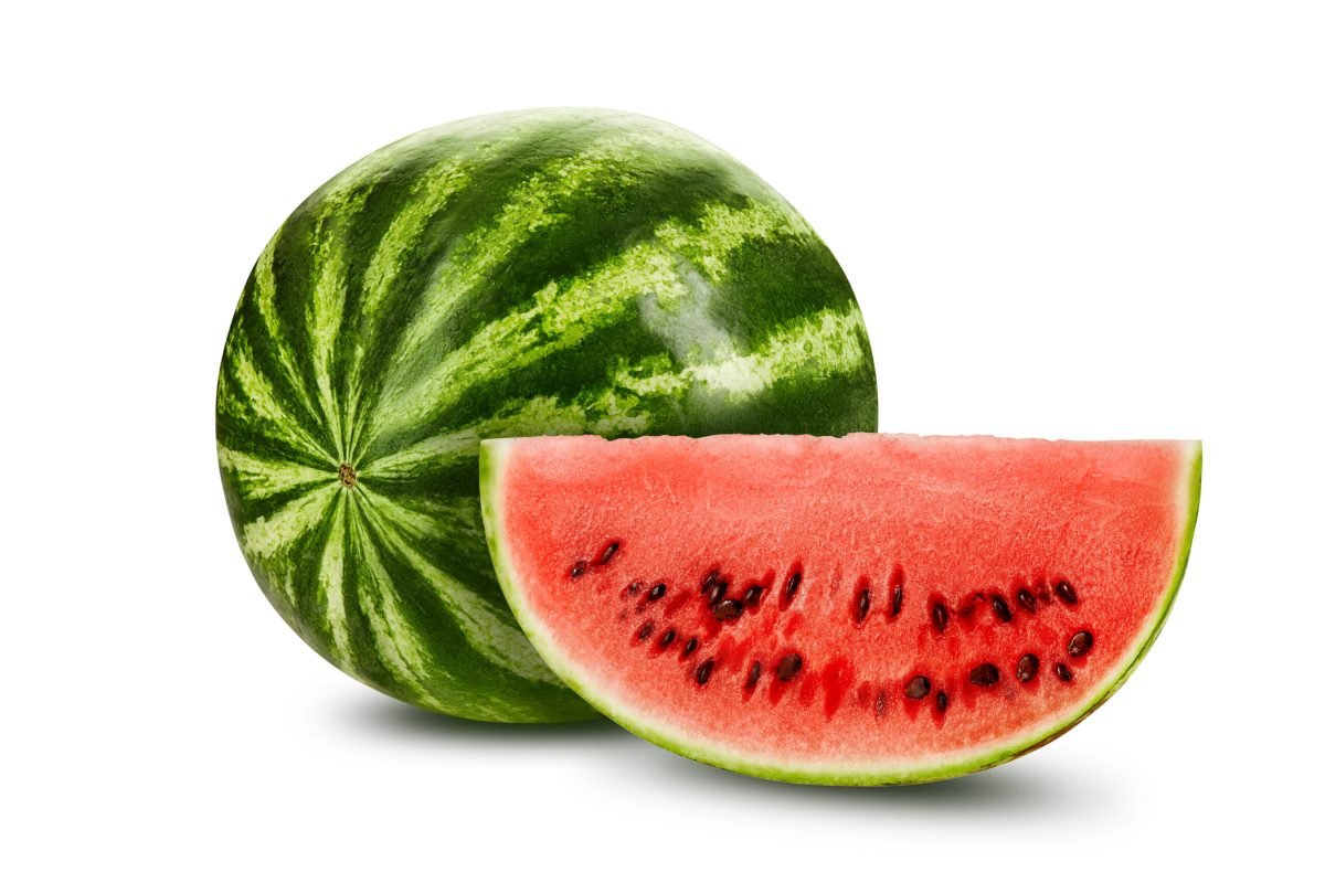 Green, striped, ripe watermelon with a slice in a cross-section, isolated on white background with copy space for text or images. Special kind of a berry. Sweet pink flesh with black seeds. Side view. Close-up shot.